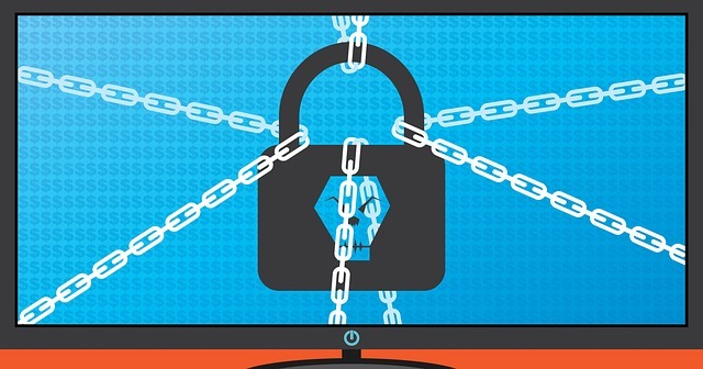 Graphic of a computer locked by a ransomware attack showing a skull on a padlock with chains wrapped around it Image by Katie White from Pixabay