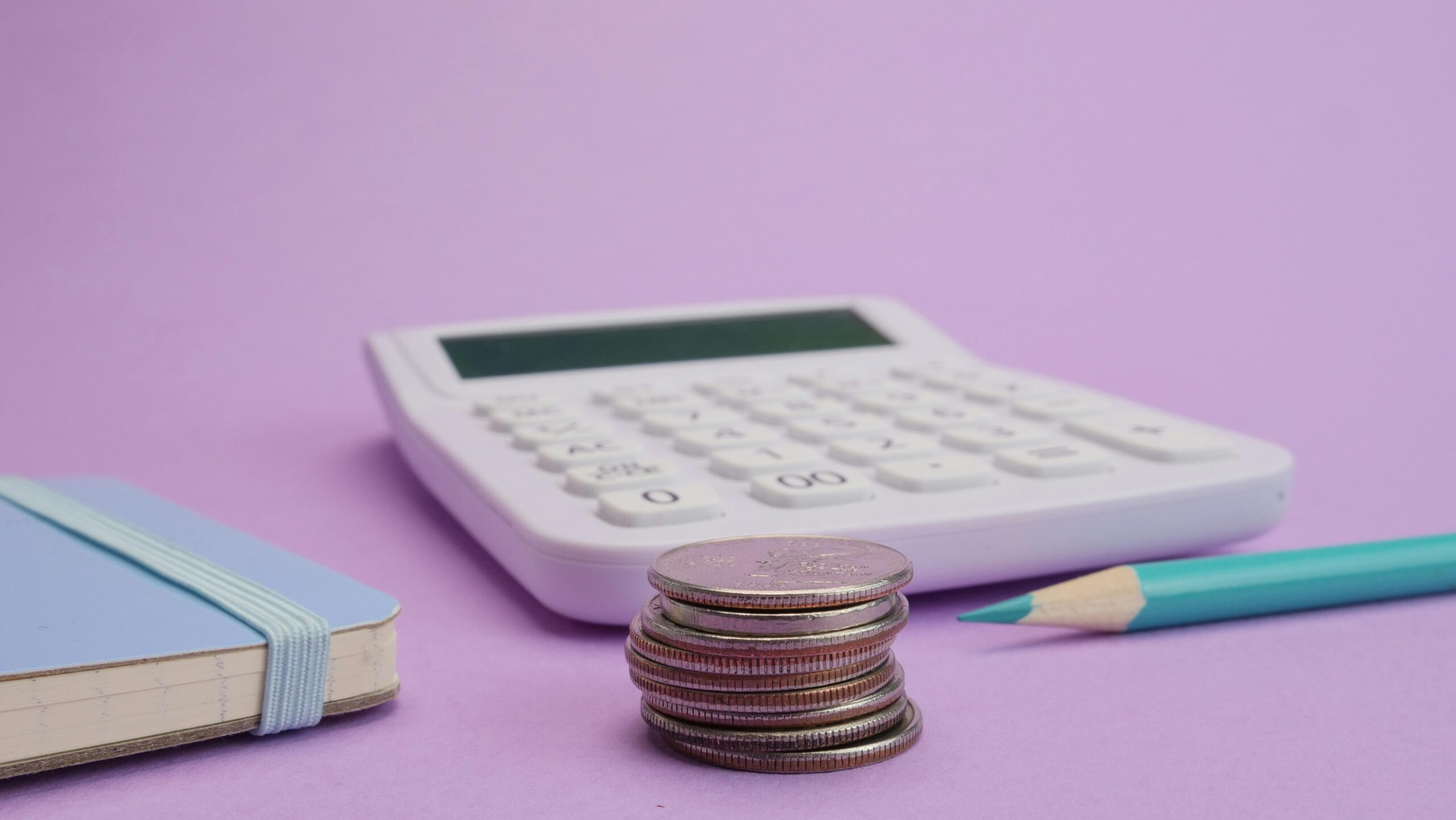 Photo by Kindel Media: https://www.pexels.com/photo/close-up-shot-of-stacked-coins-on-a-purple-background-7054801/