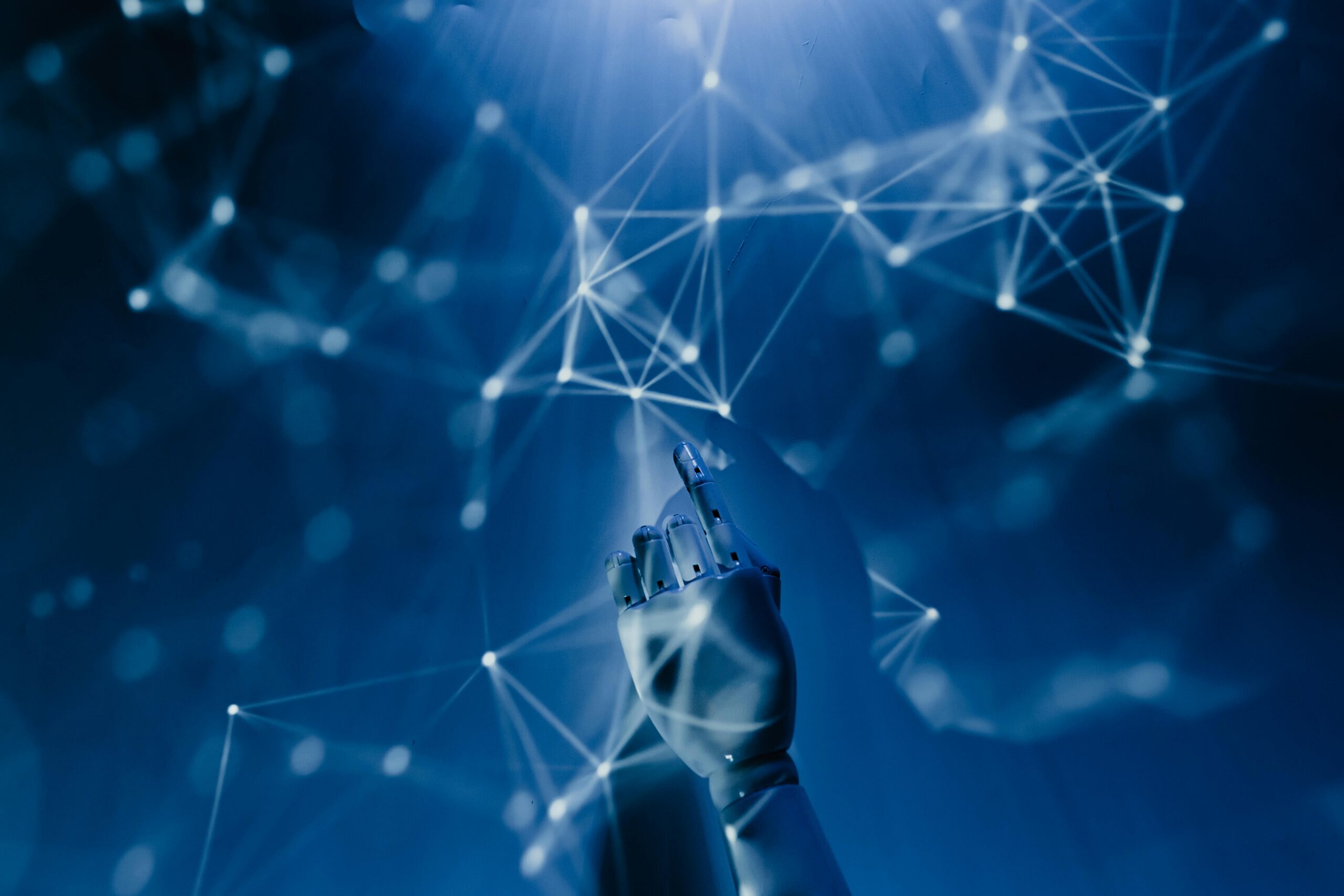 Free A robotic hand reaching into a digital network on a blue background, symbolizing AI technology. Stock Photo https://www.pexels.com/photo/robot-pointing-on-a-wall-8386440/