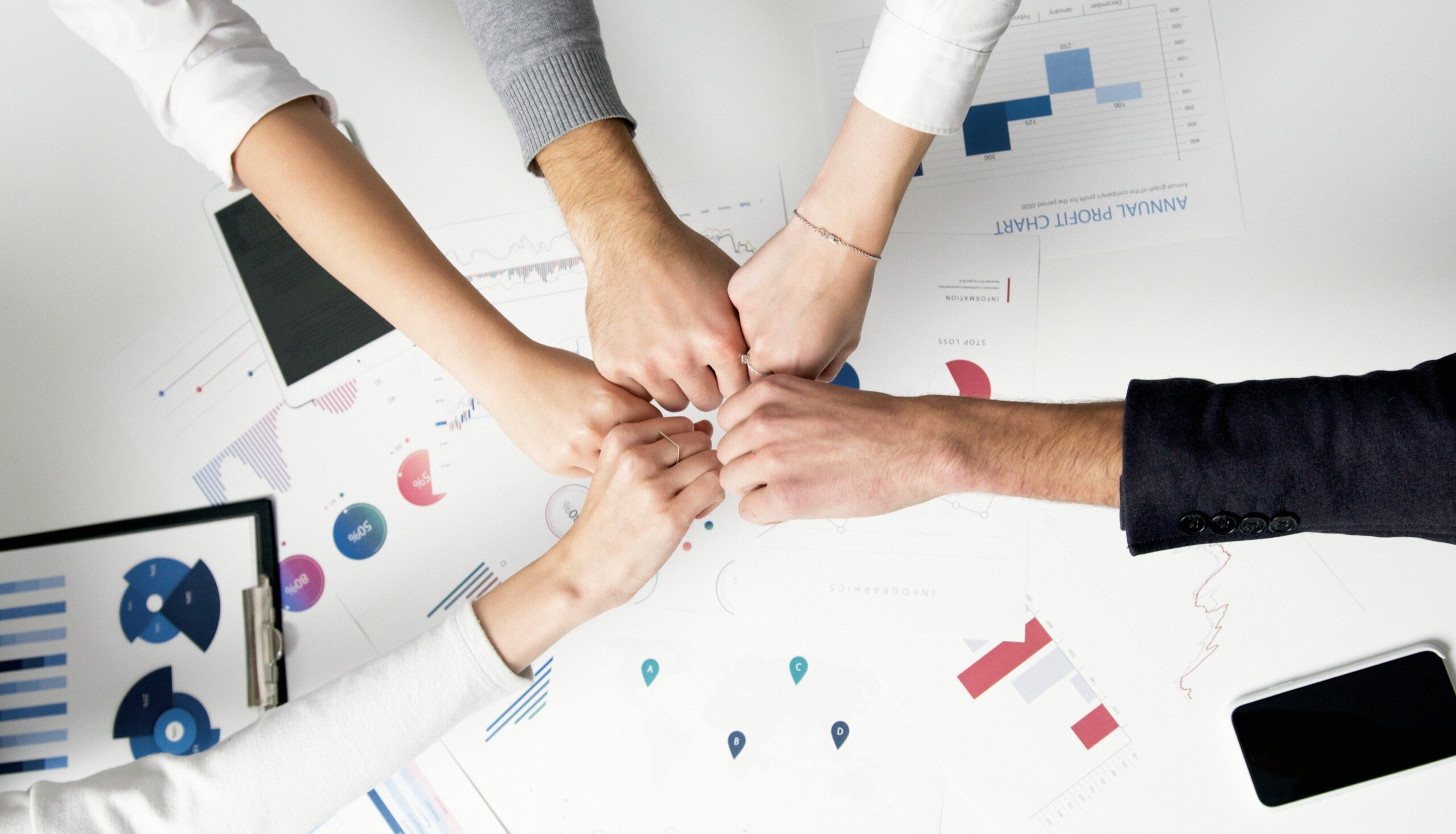 Free Colleagues celebrate success with a fist bump over financial charts depicting teamwork and unity. Stock Photo https://www.pexels.com/photo/persons-hand-with-silver-ring-5716037/