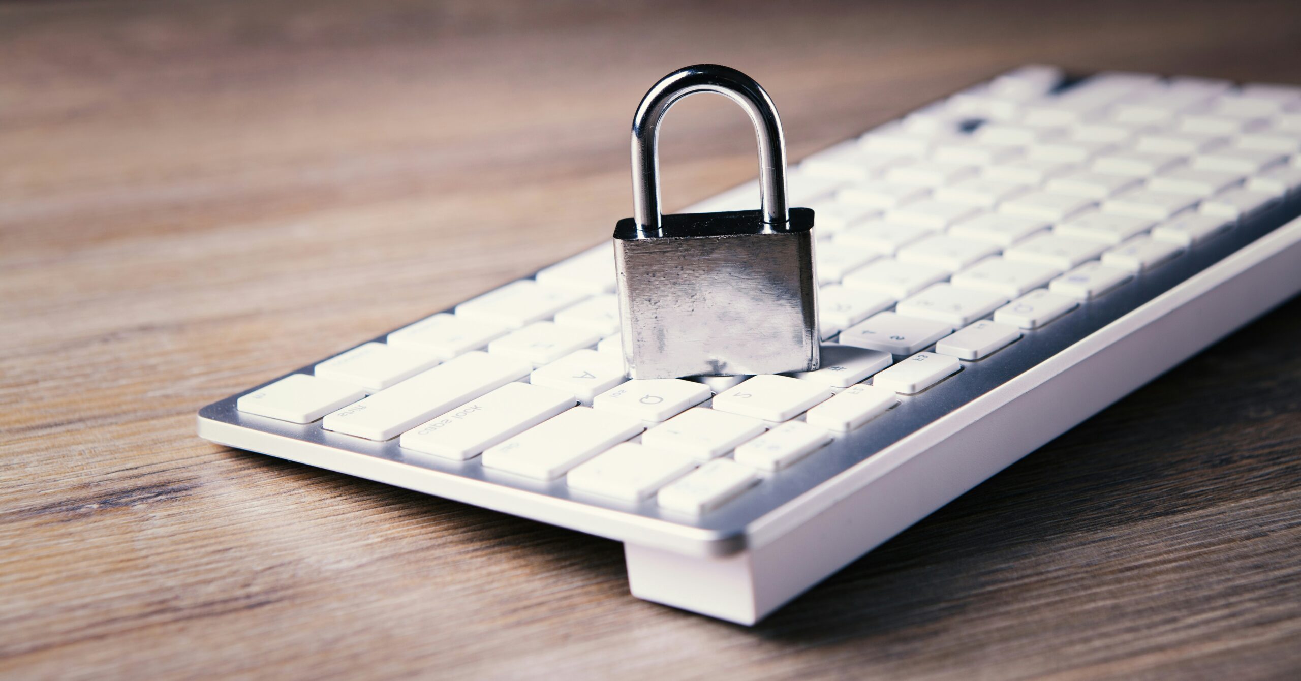 a computer keyboard with a padlock on top of it https://unsplash.com/photos/a-computer-keyboard-with-a-padlock-on-top-of-it-2T4l02ZYj-k