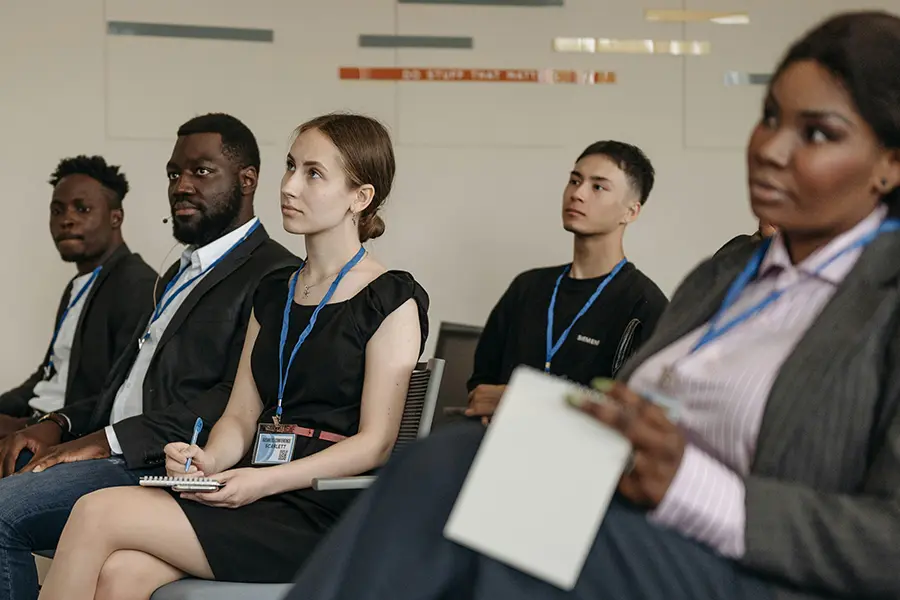 Cybersecurity Training photo by Pavel Danilyuk: https://www.pexels.com/photo/multiracial-people-sitting-on-chairs-8761320/